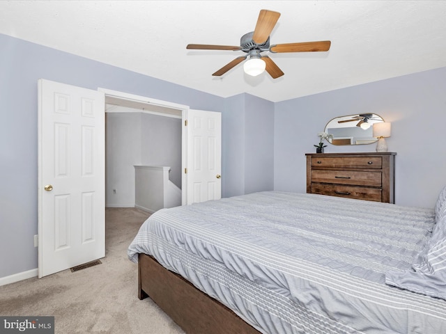 bedroom featuring visible vents, carpet floors, baseboards, and ceiling fan