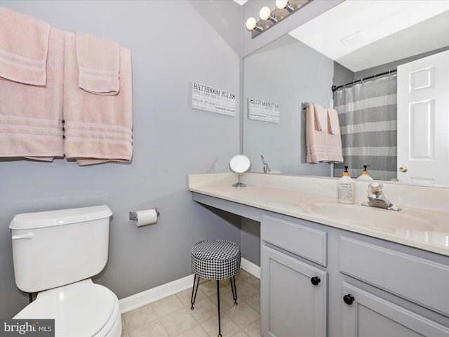 bathroom with tile patterned floors, baseboards, toilet, and vanity