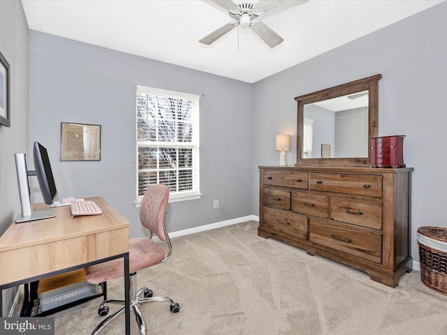 office space with baseboards, light colored carpet, and a ceiling fan