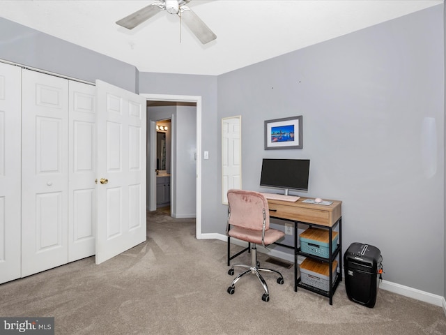 office space with carpet flooring, ceiling fan, and baseboards