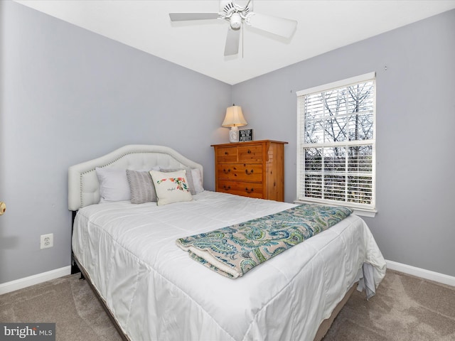 carpeted bedroom with baseboards and ceiling fan