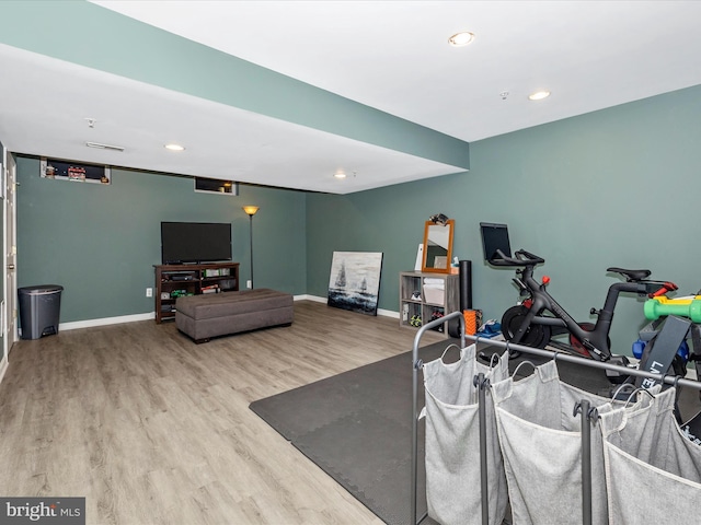 exercise room featuring recessed lighting, baseboards, and wood finished floors