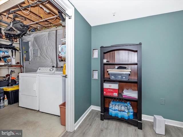 washroom with washer and dryer, laundry area, and baseboards