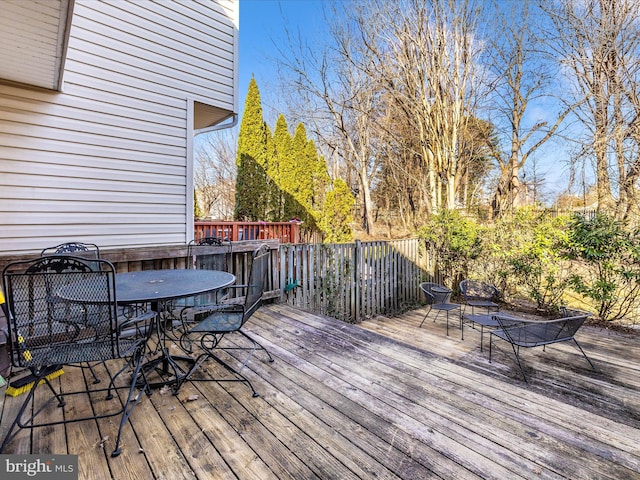 wooden deck featuring outdoor dining area