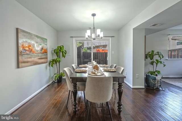 dining area with visible vents, baseboards, dark wood-style floors, and a chandelier