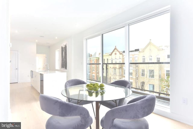 dining space featuring light wood-style floors