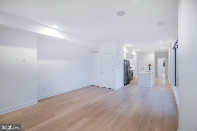 unfurnished living room featuring recessed lighting, visible vents, baseboards, and light wood finished floors