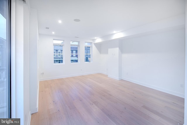 unfurnished room featuring visible vents, recessed lighting, light wood-style floors, and baseboards