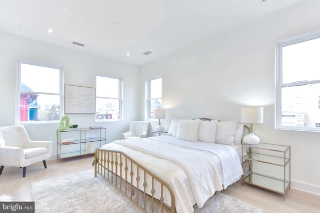 bedroom featuring recessed lighting, wood finished floors, visible vents, and baseboards