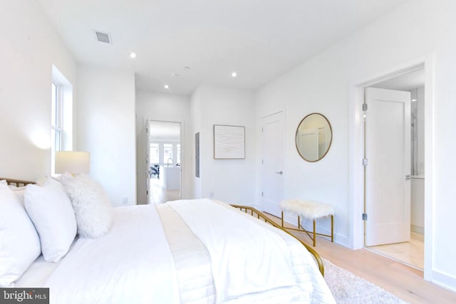 bedroom with visible vents, recessed lighting, baseboards, and wood finished floors