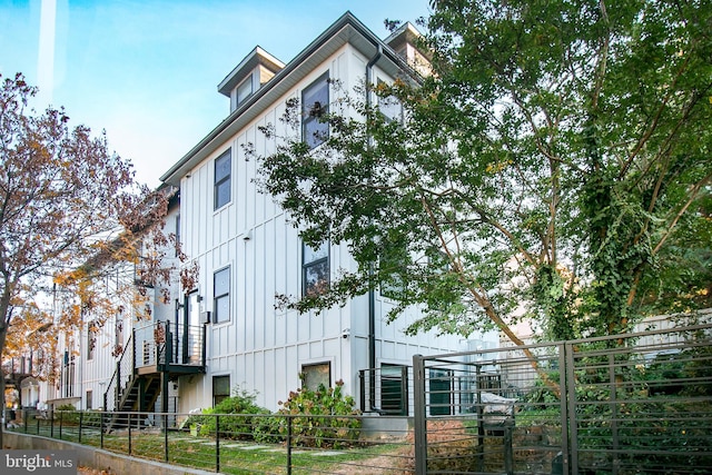 view of property exterior with a fenced front yard and board and batten siding