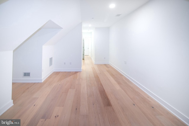 bonus room featuring baseboards, visible vents, and light wood-type flooring