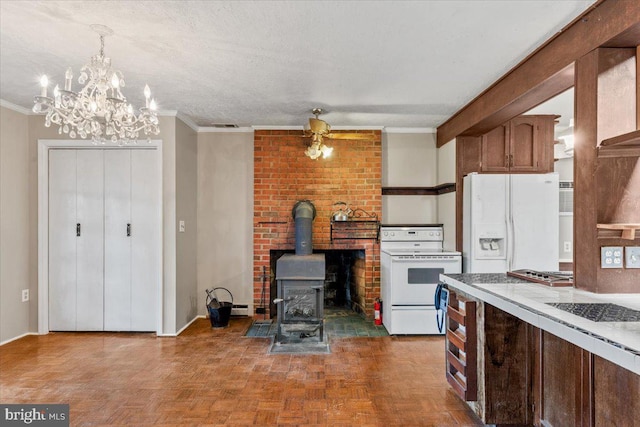 306 Burnt Church Rd, Winchester, VA 22603 - kitchen with a textured ceiling, white appliances, ornamental molding, a wood stove, and a notable chandelier