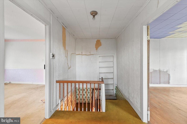 306 Burnt Church Rd, Winchester, VA 22603 - hallway featuring wood finished floors, an upstairs landing, and a textured wall