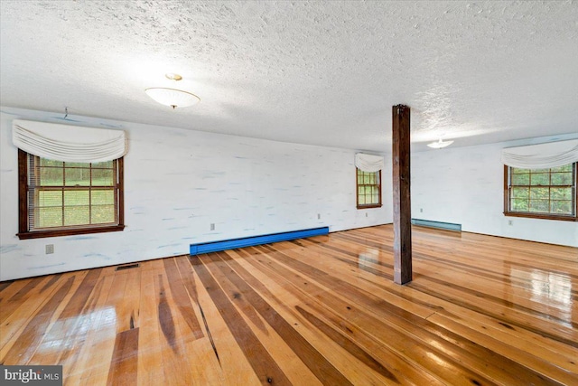 306 Burnt Church Rd, Winchester, VA 22603 - spare room with a textured ceiling, visible vents, a baseboard radiator, hardwood / wood-style flooring, and a baseboard heating unit