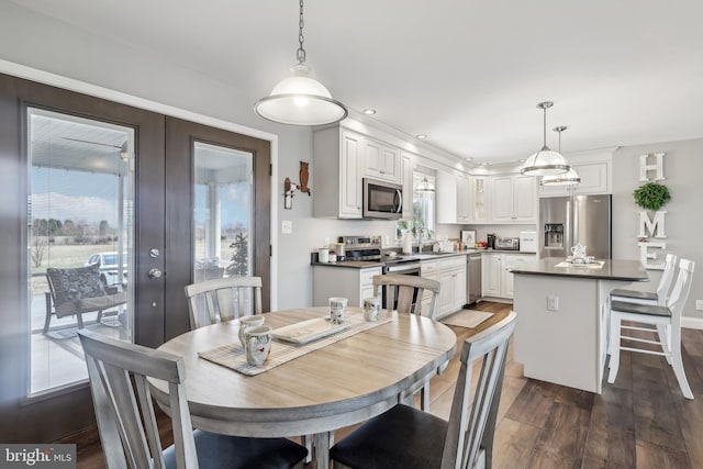 dining area with recessed lighting, french doors, and dark wood-type flooring