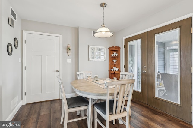 dining room with french doors, baseboards, visible vents, and dark wood-style floors