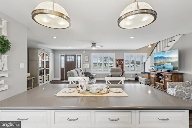 kitchen featuring dark countertops, open floor plan, recessed lighting, white cabinetry, and a ceiling fan