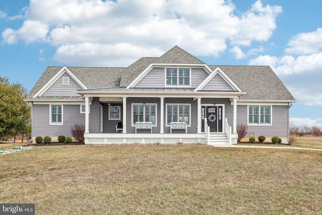 view of front of home with a porch, a front lawn, and a shingled roof