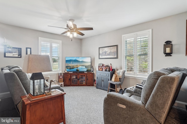 living room featuring carpet flooring, a ceiling fan, and plenty of natural light