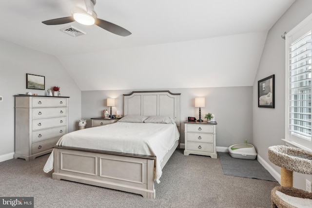 carpeted bedroom featuring baseboards, lofted ceiling, visible vents, and a ceiling fan