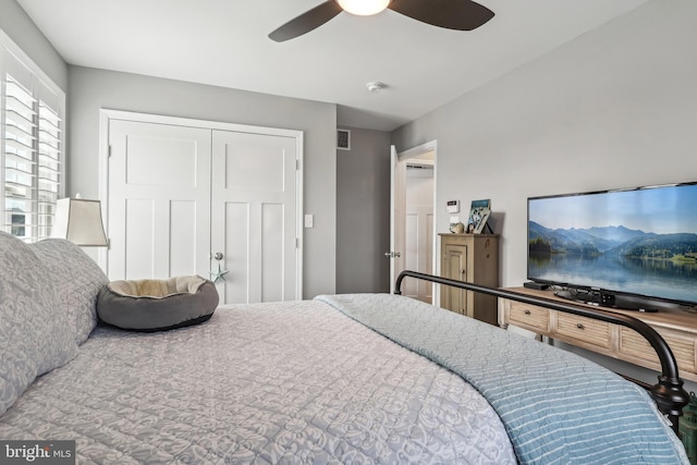 bedroom with a closet, visible vents, and ceiling fan