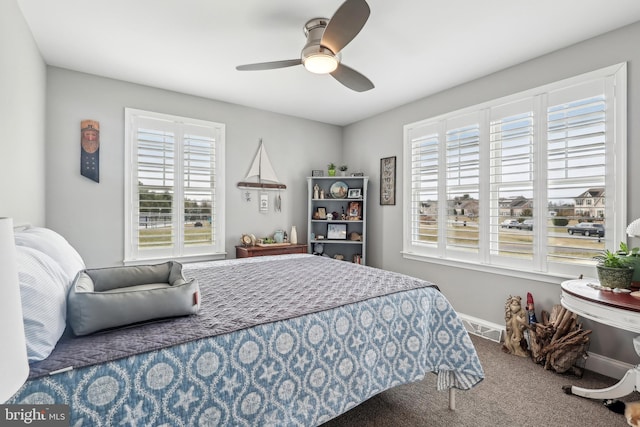 bedroom featuring visible vents, a ceiling fan, carpet, and baseboards