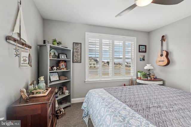 bedroom with a ceiling fan, baseboards, and carpet floors