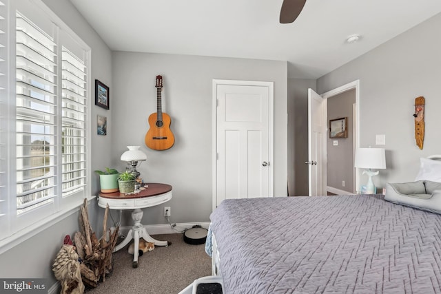 carpeted bedroom featuring ceiling fan and baseboards