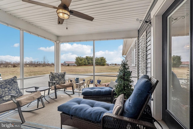 sunroom featuring a ceiling fan