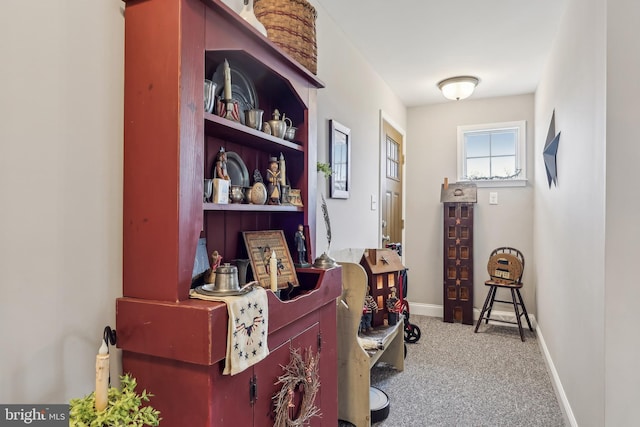 interior space with carpet flooring and baseboards