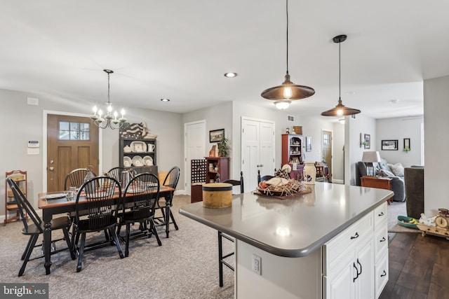 kitchen with a kitchen island, decorative light fixtures, recessed lighting, a notable chandelier, and white cabinets