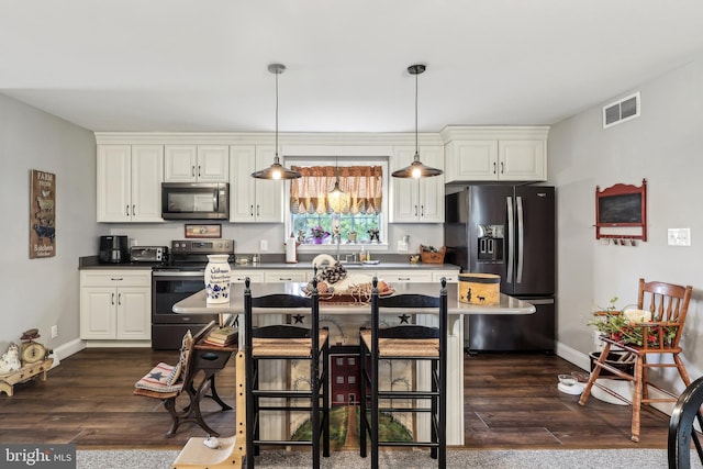 kitchen featuring stainless steel electric range oven, black fridge with ice dispenser, visible vents, and dark wood-style flooring