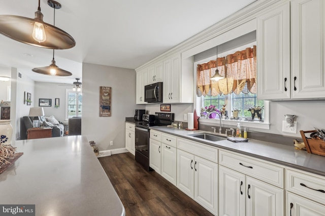 kitchen with electric range, a sink, dark wood-style floors, white cabinetry, and black microwave