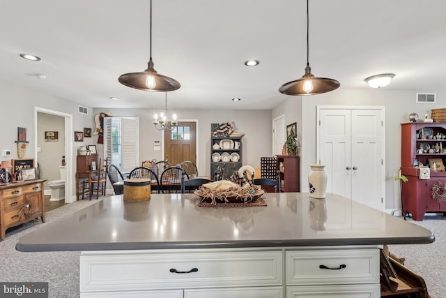 kitchen with visible vents, an inviting chandelier, recessed lighting, white cabinets, and pendant lighting