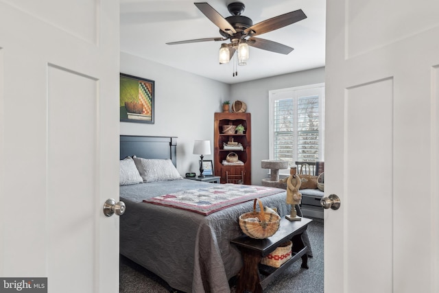 bedroom with a ceiling fan and carpet