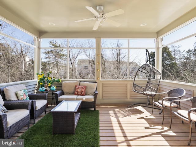 sunroom featuring ceiling fan