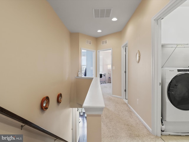 laundry area featuring visible vents, washer / dryer, baseboards, and carpet floors