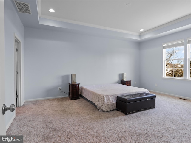 bedroom featuring visible vents, a raised ceiling, and carpet floors