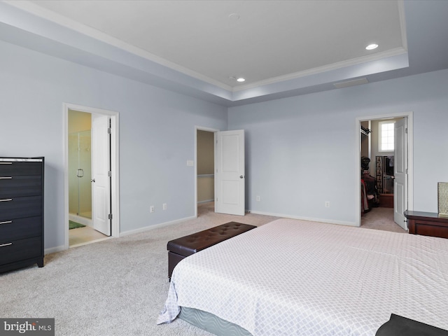 bedroom featuring a spacious closet, baseboards, light colored carpet, a tray ceiling, and recessed lighting