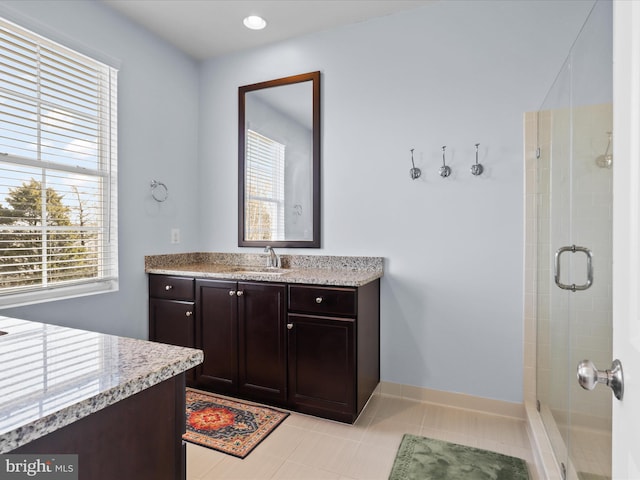 full bathroom featuring tile patterned floors, a stall shower, recessed lighting, baseboards, and vanity