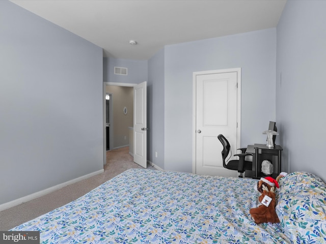 carpeted bedroom with visible vents and baseboards