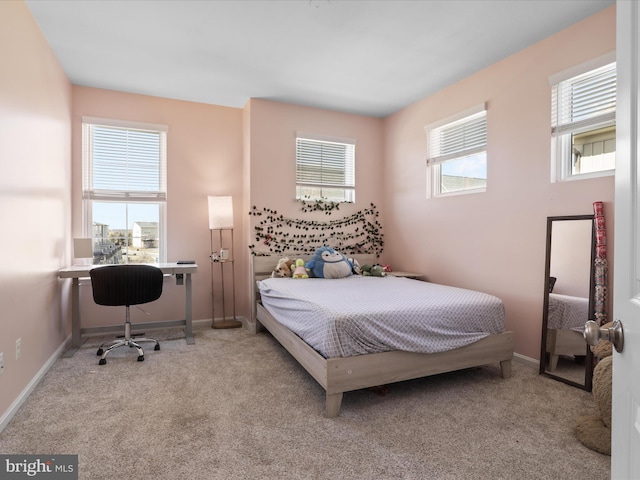 carpeted bedroom with baseboards