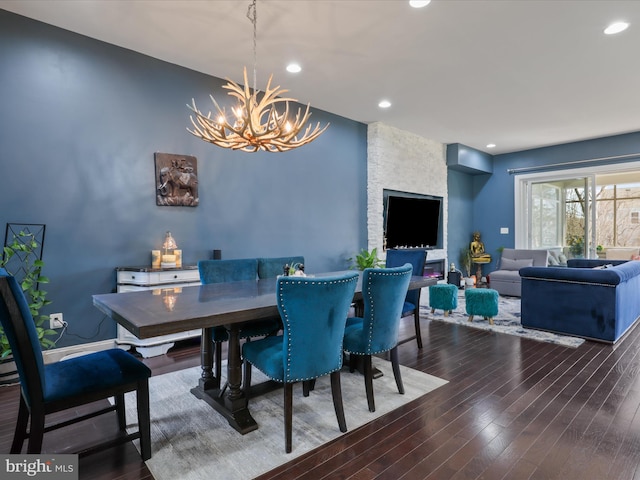 dining space featuring a chandelier, recessed lighting, and wood finished floors