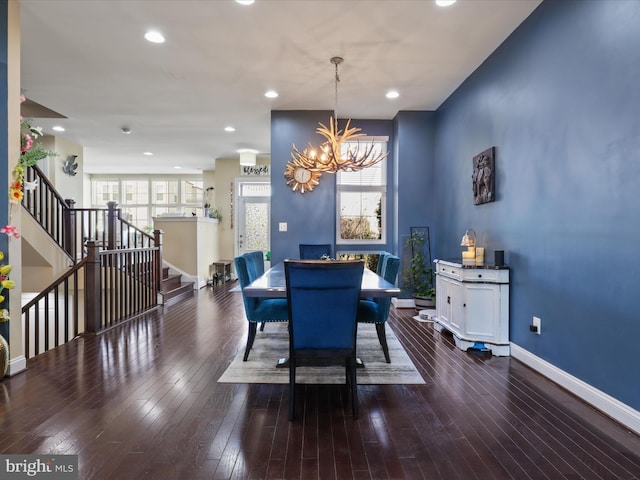 dining space with stairway, plenty of natural light, and hardwood / wood-style flooring