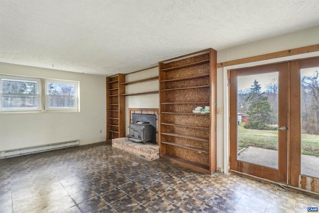 unfurnished living room with tile patterned floors, a textured ceiling, french doors, a baseboard radiator, and a wood stove