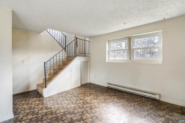 unfurnished living room with stairs, baseboards, baseboard heating, and a textured ceiling