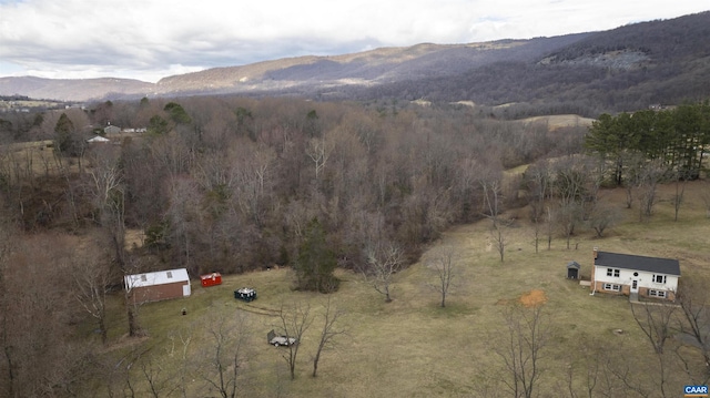 aerial view featuring a mountain view, a rural view, and a wooded view