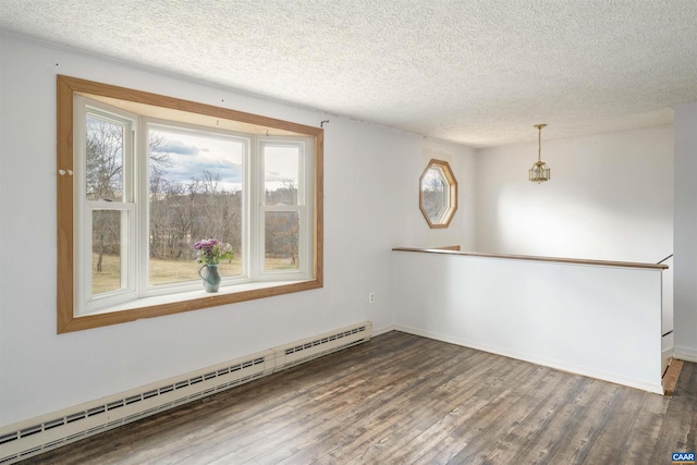 unfurnished room with plenty of natural light, wood finished floors, and a baseboard radiator