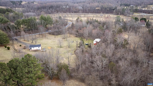 birds eye view of property featuring a rural view and a view of trees